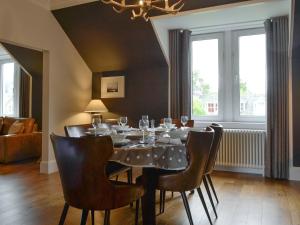 a black dining room with a table and chairs at Darroch View in Ballater