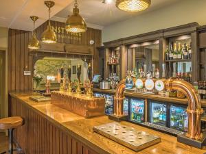 a bar with a large wooden counter with a barraged at Henning Lodge - Uk31008 in Ansty