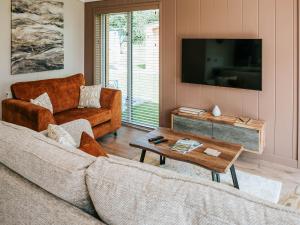 a living room with a couch and a table at Rue - Uk51100 in Clitheroe