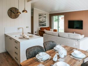 a kitchen and living room with a table and a couch at Rue - Uk51100 in Clitheroe