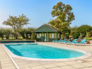 a swimming pool with lounge chairs and a gazebo at Pattiswick Hall in Stisted
