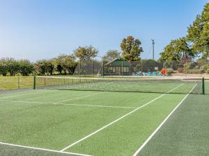a tennis court with a net on top of it at Pattiswick Hall in Stisted