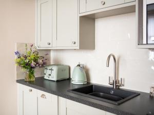 a kitchen counter with a sink and a toaster at Running Hare - Uk7558 in Inverness