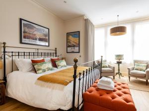 a bedroom with a bed and a chair at Running Hare - Uk7558 in Inverness