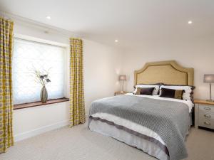 a bedroom with a large bed and a window at Barn End - Uk32694 in Horton +3 photos