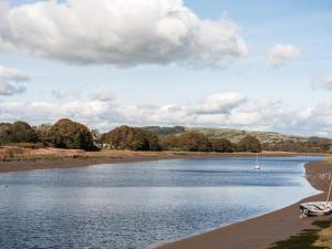 a body of water with two boats on the shore at Auchengool House in Kirkcudbright