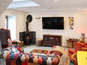 a living room with a couch and a fire place at Y-Beudy Bach - Uk51421 in Llandeilo