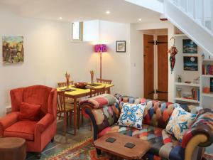 a living room with a couch and chairs and a table at Y-Beudy Bach - Uk51421 in Llandeilo