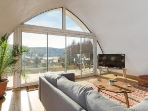 a living room with a large window and a couch at Jill Strawbale House- Ukc2935 in Strontian
