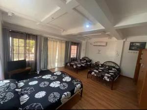 a room with three beds in a room at Valdez & Ismail HOMESTAY in Apatot