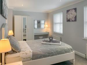 a bedroom with a bed with two shoes on it at Ty Ffynnon - Hw7601 in Llansantffraid