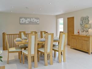 a dining room with a wooden table and chairs at Honey Pippin in Cheriton Bishop