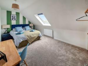 a bedroom with a bed and a table in it at No 2 Badger Sett-Uk44307 in Lenwade +13 photos