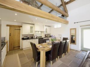 a kitchen and dining room with a wooden table and chairs at Dale House in Castleton