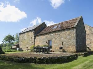 an old stone building with a table in front of it at Dale House in Castleton +4 photos