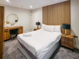 a bedroom with a bed and a desk and a mirror at Uk47852 - No 1B in Aberystwyth