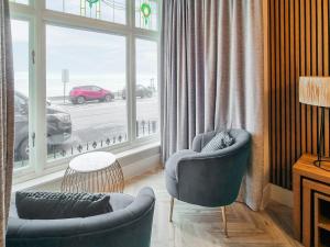 a living room with two chairs and a large window at Uk47852 - No 1B in Aberystwyth