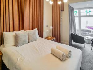 a bedroom with a white bed with two towels on it at Uk47852 - No 1B in Aberystwyth
