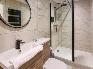 a bathroom with a sink and a toilet and a mirror at Uk47852 - No 1B in Aberystwyth +2 photos