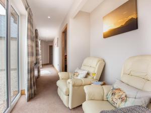 a living room with two chairs and a couch at Morven View in Dunbeath