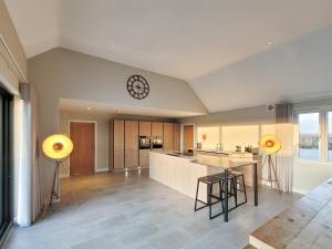 a kitchen with a counter and a clock on the ceiling at The Willows - Ukc4617 in Dunholme
