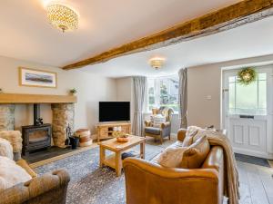 a living room with furniture and a fireplace at Barngarth in Cartmel
