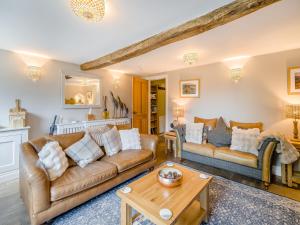 a living room with two couches and a table at Barngarth in Cartmel +17 photos