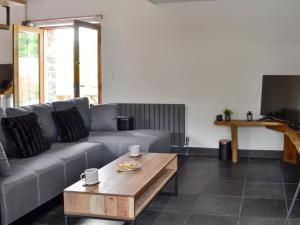 a living room with a couch and a coffee table at Caffi Sali - Weluk143 in Blaenpenal