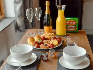 a table with a plate of food and wine glasses at Caffi Sali - Weluk143 in Blaenpenal