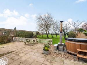 a patio with a bench and a hot tub at Greenbank Farm in Weeton