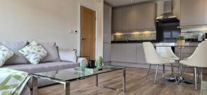 a living room with a couch and a glass table at Cozy 2BR apartment in Maidenhead Sleeps 6 in Maidenhead