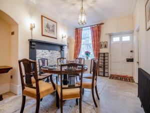 a dining room with a table and chairs and a fireplace at Rock House in Wells