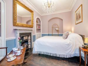 a bedroom with a bed and a fireplace at Rock House in Wells