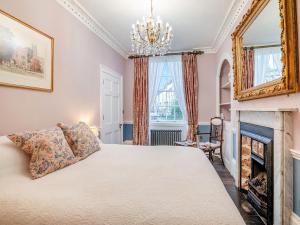 a bedroom with a bed and a fireplace at Rock House in Wells +10 photos