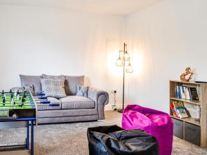 a living room with a couch and a chess board at Chestnuts in Burgh by Sands