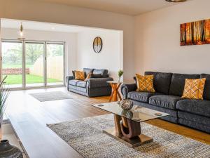 a living room with a couch and a table at Chestnuts in Burgh by Sands