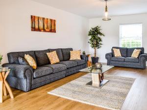 a living room with a couch and a table at Chestnuts in Burgh by Sands