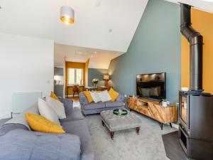 a living room with a couch and a tv at Shoreside in Aberfeldy