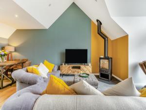 a living room with two couches and a tv at Shoreside in Aberfeldy