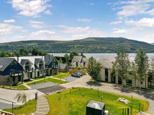 a row of houses with a lake in the background at Shoreside in Aberfeldy +10 photos