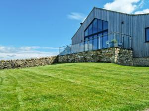 a house on a hill with a stone wall at The Barn At Toft Hill Hall in High Etherley