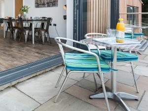 a table and chairs sitting on a patio at The Barn At Toft Hill Hall in High Etherley