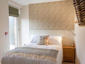 a bedroom with a large bed and a brick wall at Courtyard - Uk7554 in Inverness