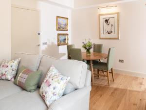 a living room with a couch and a table at Courtyard - Uk7554 in Inverness
