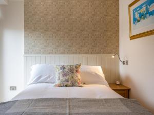 a bedroom with a bed with a pillow on it at Courtyard - Uk7554 in Inverness