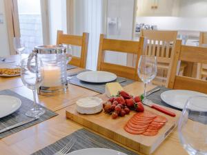 a table with cheese and meats on a cutting board at Mungeon Barn - Uk30125 in Backbarrow