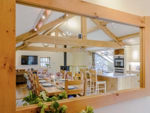 a dining room and kitchen with a large window at Mungeon Barn - Uk30125 in Backbarrow +17 photos