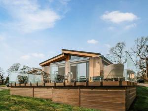 a house with a large deck on the grass at Elmore - Uk51111 in Clitheroe