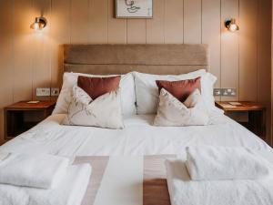 a large bed with white sheets and pillows at Elmore - Uk51111 in Clitheroe +6 photos