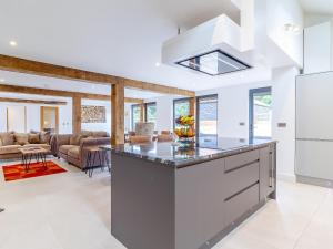 a kitchen with a large island and a living room at Kestrel Barn-Uk31353 in Swaffham +23 photos
